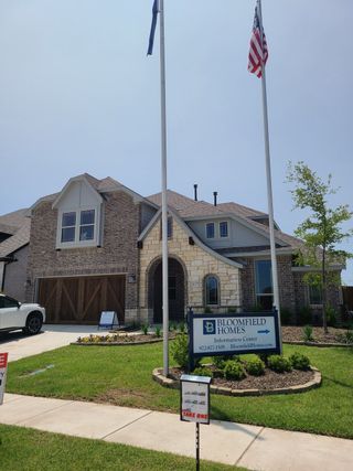 Street view A beautiful brick home with a landscaped yard in Stone River Glen 60s by Bloomfield Homes (Royse City, TX).