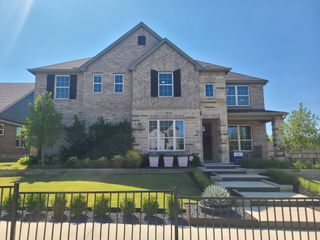 Model Home A beautiful brick home with manicured landscaping in Highland Lakes by Pulte Homes (McKinney, TX).