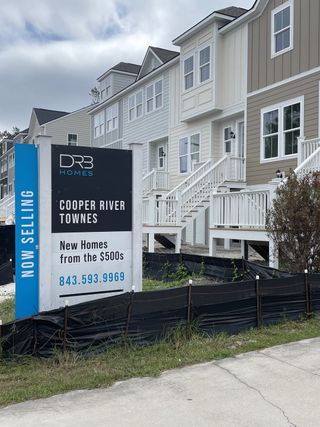 A modern townhouse development in Cooper River Townes by DRB Homes, showcasing sleek design in North Charleston, SC.