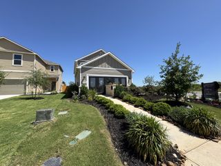 Street view Charming gray home with manicured landscaping in Blue Ridge Ranch by Century Communities (San Antonio, TX).