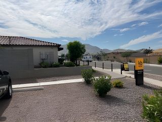 A contemporary home with a tiled roof and landscaped surroundings in Dobbins Manor Classics by KB Home (Phoenix, AZ).