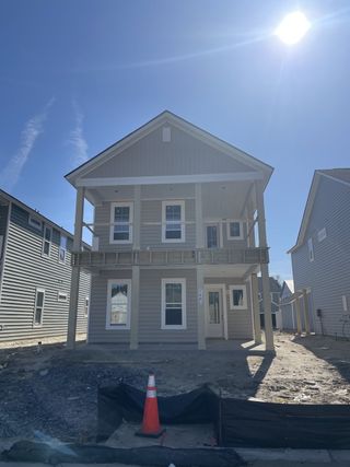 A modern two-story home with a sleek design in Heron's Walk at Summers Corner: Row Collection by Lennar (Ridgeville, SC).