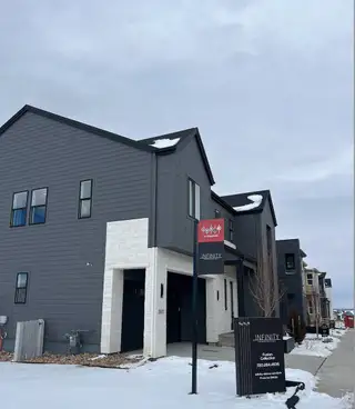 Street view Sleek dark-toned home with modern design and white accents in Lyric at Ridgegate by Infinity Properties (Lone Tree, CO).