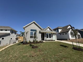 Street view Charming gray home with a sloped lawn in Loyola by Milestone Community Builders (Austin, TX).