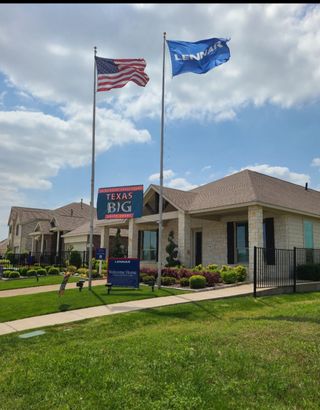 A charming stone home with manicured landscaping in Preserve at Honey Creek by Lennar, McKinney, TX.