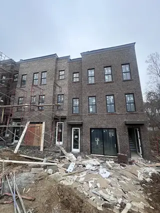 Street view An under-construction brick townhouse in Echo Park by UnionMain Homes, Suwanee, GA.