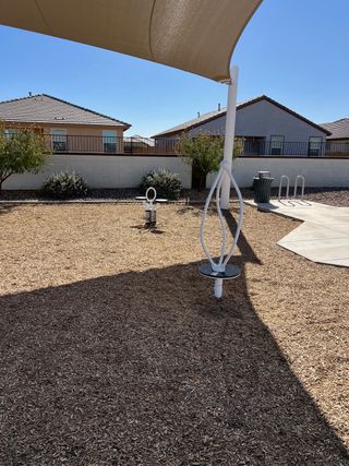 Charming community playground with a shaded area in Anderson Farms: Arbor by Lennar (Maricopa, AZ).