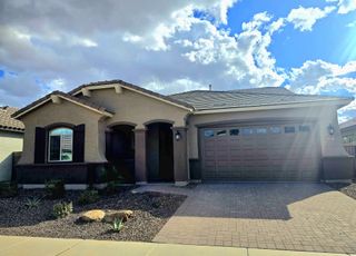 A beautiful home with arched entry and neat landscaping in North Shore at Escalante by Fulton Homes (Surprise, AZ).