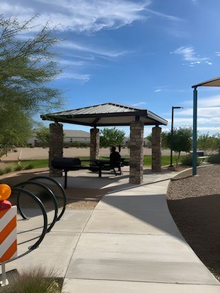 Scenic community park pavilion in Rio Rancho Estates by D.R. Horton, featuring shaded seating in Surprise, AZ.