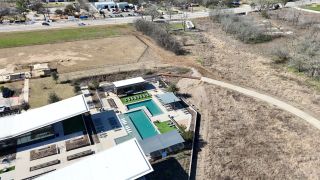 Community Amenities Aerial view of a modern pool area and pathways in Easton Park - Nelson Village 34’ by David Weekley Homes (Austin, TX).