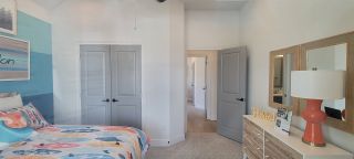 Model Home A vibrant bedroom with bold blue walls, a vaulted ceiling, and a contemporary design.