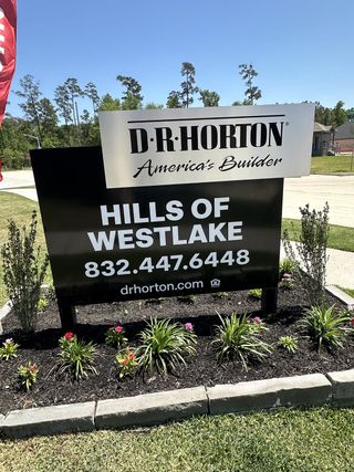 Street view D.R. Horton welcomes you to the lush Hills of Westlake in Conroe, TX, featuring vibrant landscaping and a serene setting.