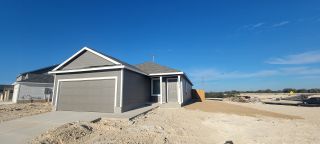 Street view A charming gray single-story home with a pitched roof in Landon Ridge by Lennar, San Antonio, TX.