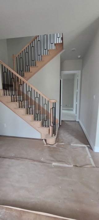 A staircase with black wrought iron railings and wooden steps, giving a modern yet classic feel.