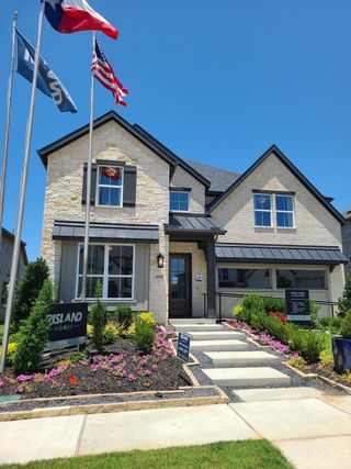 A beautiful stone-facade home with manicured landscaping in Creekview Meadows by Risland Homes (Celina, TX).