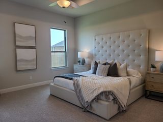 A cozy bedroom with a plush tufted headboard, soft lighting, and neutral decor accents creating a serene atmosphere.