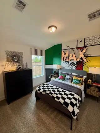A vibrant bedroom with comic-themed wall art, cozy bedding, and modern decor.
