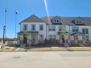 Elegant townhome with a modern facade in Village on Main Street by CB JENI Homes (Frisco, TX).