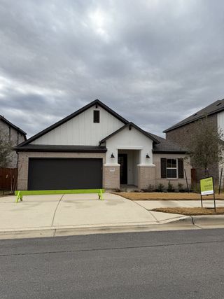 A charming single-story home with a modern design in Park Collection at Lariat by Tri Pointe Homes (Liberty Hill, TX).