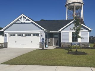 A charming blue and gray ranch-style home with a spacious garage in Somerset Two-Story Homes by Ryan Homes (Santee, SC).