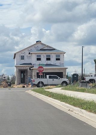 A new home under construction at Ridgeview by Trinity Family Builders in Clermont, FL, showcasing modern design elements.