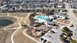 A vibrant community with a pool, playground, and pathways in Orchard Ridge by CastleRock Communities (Liberty Hill, TX).