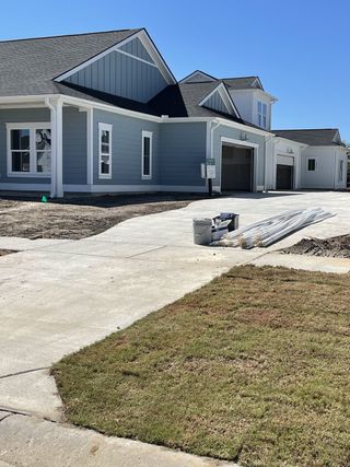 A sleek blue home with white trim and a spacious driveway in Horizons at Carnes Crossroads by Lennar (Summerville, SC).