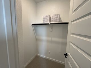 A spacious walk-in closet featuring ample shelving and sleek design, perfect for organized storage.
