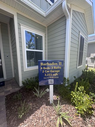 Charming modern home with gray siding in Russell Retreat by Lennar, Green Cove Springs, FL. Relax in a stylish urban setting.