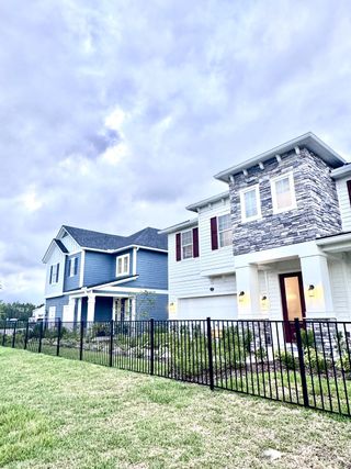 Charming homes with stone accents and lush landscaping in Brook Forest by Dream Finders Homes (St. Augustine, FL).