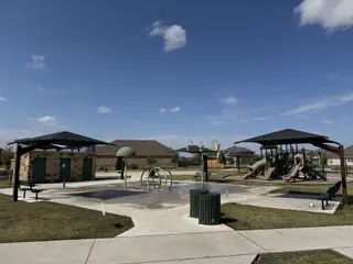 Community Amenities A delightful community park with playground and seating in Highlands North by Brightland Homes (Hutto, TX).