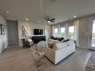 A spacious living room with neutral tones, large windows, cozy sofas, and modern decor.
