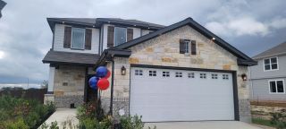 A beautiful stone-accented home with modern charm in Timber Creek by First America Homes (San Antonio, TX).