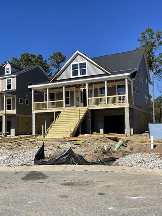 A charming two-story home with a spacious porch in The Retreat at Brownswood by Eastwood Homes (Johns Island, SC).