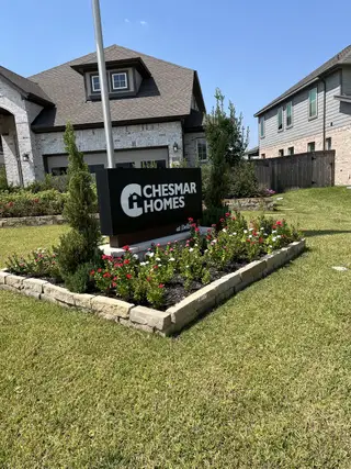 Beautiful Chesmar Homes at Dellrose in Hockley, TX, featuring lush landscaping and a welcoming community vibe.