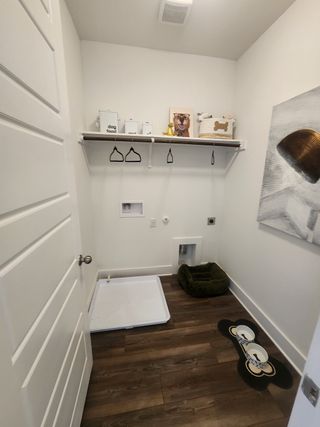 A cozy pet room with a dog bed, feeding station, and storage shelves, ideal for your furry friend.