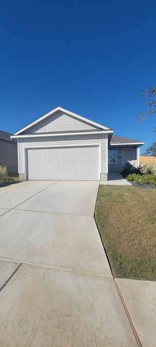 Street view A charming gray home with a spacious driveway in Brookmill: Watermill Collection by Lennar (San Antonio, TX).