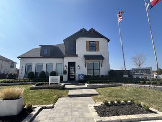 A stunning model home exterior with a modern farmhouse design in Solterra Texas by Highland Homes (Mesquite, TX).