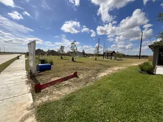 Street view Expansive open space with sidewalks and pavilion in Sweetgrass Village: Landmark Collection by Beazer Homes (Crosby, TX).
