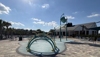 A vibrant community pool with playful features in Harmony West by D.R. Horton, St. Cloud, FL.