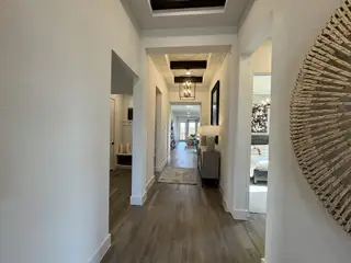 Hallway: A grand hallway with tray ceilings and elegant lighting.
