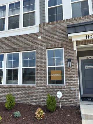 A modern brick townhouse with elegant windows in Grove 98 by Stanley Martin Homes (Wake Forest, NC).