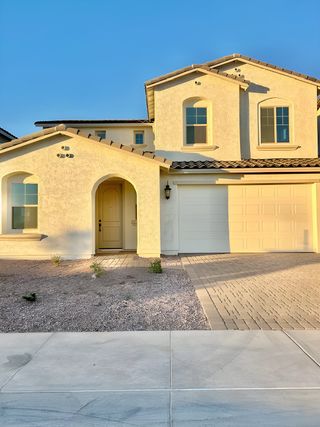 A charming Mediterranean-style home with a warm facade in Hawes Crossing Venture I Collection by Taylor Morrison (Mesa, AZ).