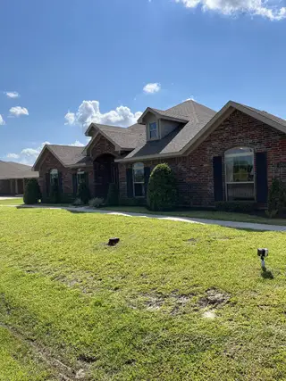 Charming brick home with manicured lawn in Pedregal by Cervelle Homes, San Leon, TX.