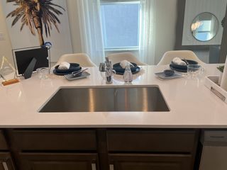 A modern kitchen island with sleek countertops, elegant settings, and stylish decor accents.