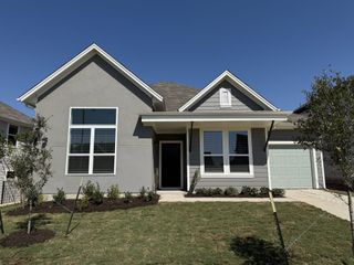 Street view A charming gray home with modern windows and a manicured lawn in Loyola by Milestone Community Builders (Austin, TX).
