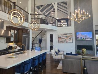 A luxurious open-concept living area with a modern kitchen, elegant lighting, and stylish furnishings.