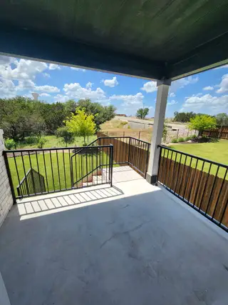 A stunning backyard view from the covered patio, overlooking a well-manicured landscape.