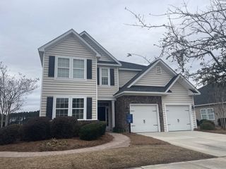 A charming two-story home with brick accents, nestled in Lindera Preserve at Cane Bay Plantation by Lennar (Summerville, SC).