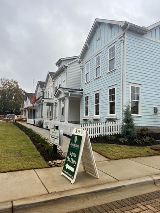 Street view Charming blue home with a white picket fence and landscaped yard in Walk23 by Meeting Street Homes & Communities (Huntersville, NC).